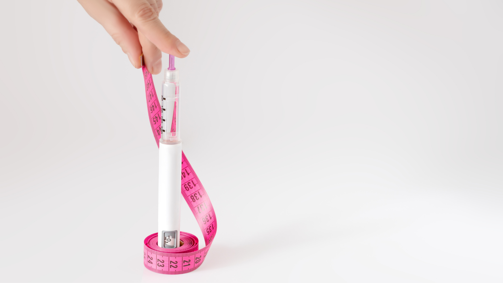 insulin pen wrapped with measuring tape